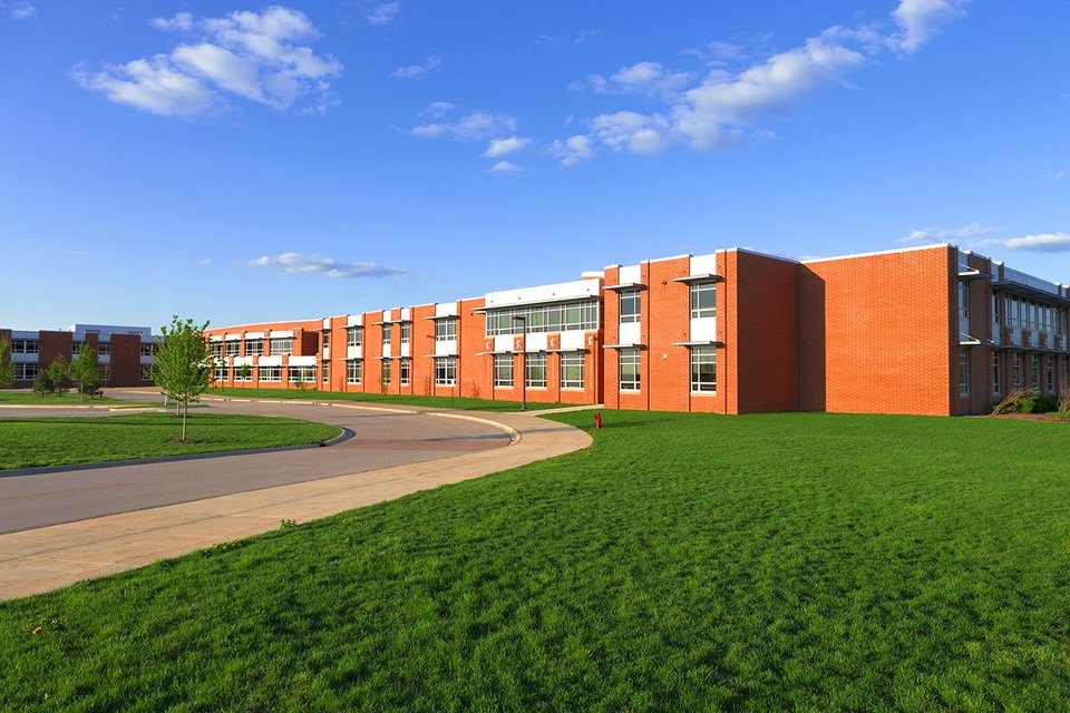 Exterior view of modern school, grass area and blue skies 