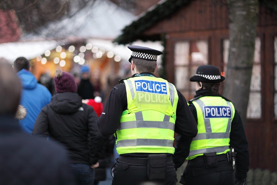 Male & female police officers on duty in a public area