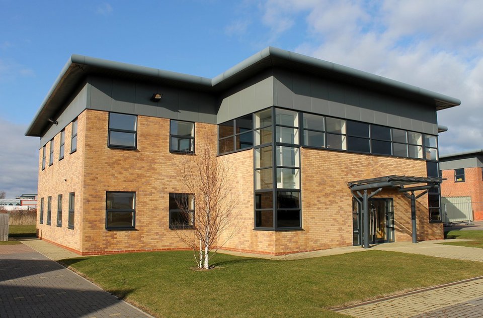 Front view of a modern office building within a business park 