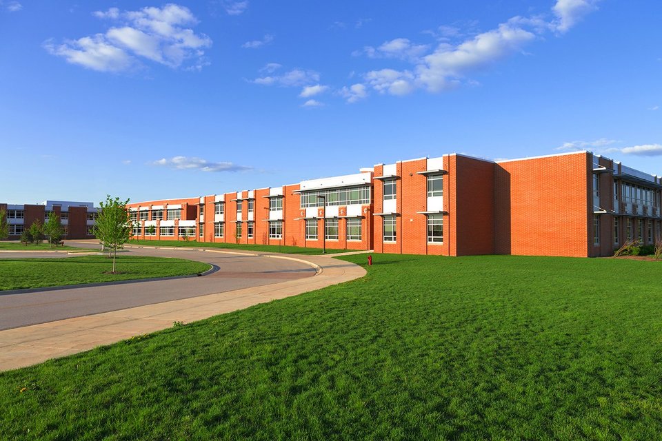 Exterior view of modern school, grass area and blue skies 