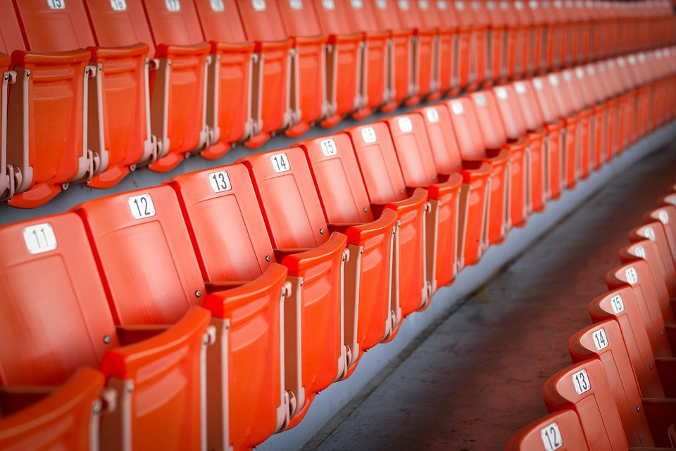 Rows of red seats at a proffessional sports stadium